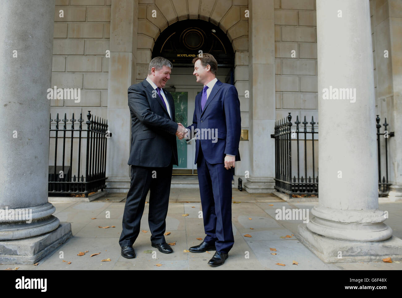 Orkney and Shetland MP Alistair Carmichael,(left) who has replaced Michael Moore as the Scottish Secretary, is greeted by Deputy Prime Minister and Liberal Democrat leader Nick Clegg, as he arrives at the Scotland Office, Whitehall, central London, after Prime Minister David Cameron, kicked off a coalition reshuffle, with Scottish Secretary Michael Moore among the casualties. Stock Photo