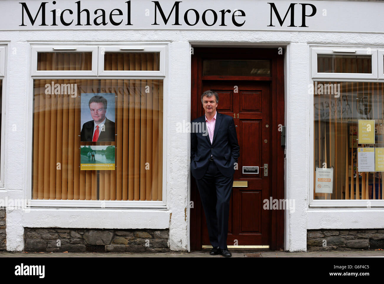 Liberal Democrat MP Michael Moore stands in the entrance to his constituency office in Galashiels after he was replaced as Scottish Secretary by Orkney and Shetland MP Alistair Carmichael as part of a coalition reshuffle. Stock Photo