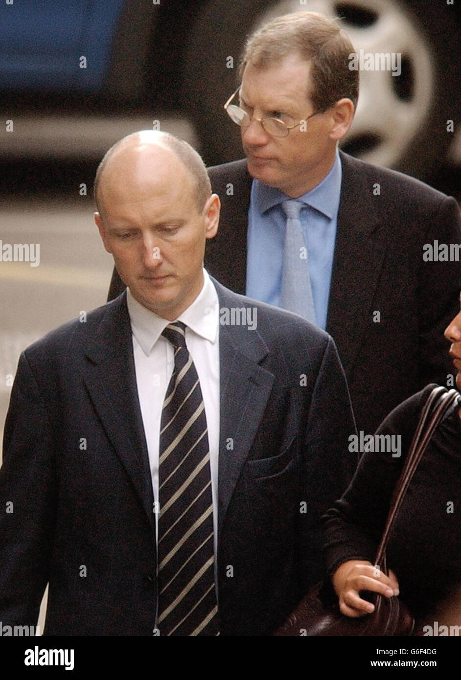 Tom Kelly and Godric Smith (front), the two official spokesmen for British Prime Minister Tony Blair, arrive to give evidence to the Hutton inquiry at the High Court in London. * The inquiry is investigating how weapons expert Dr David Kelly apparently came to take his own life after being identified as the source of the report by BBC journalist Andrew Gilligan on May 29. Stock Photo