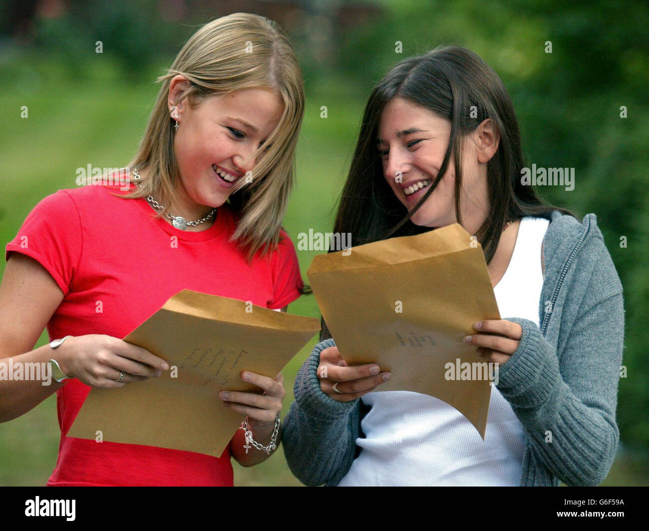 Lauren Wild (left) and Jessica Clempner smile as they open their GCSE results at Withington School for Girls in Manchester. Education Secretary Charles Clarke faced calls today to scrap GCSEs and replace them with a more flexible system, after figures showed the overall pass rate fell this year.The proportion of entrants awarded grades A* to G went down from 97.9% last year to 97.6%, while there was a fall in the number for maths GCSE scoring C or better. Stock Photo