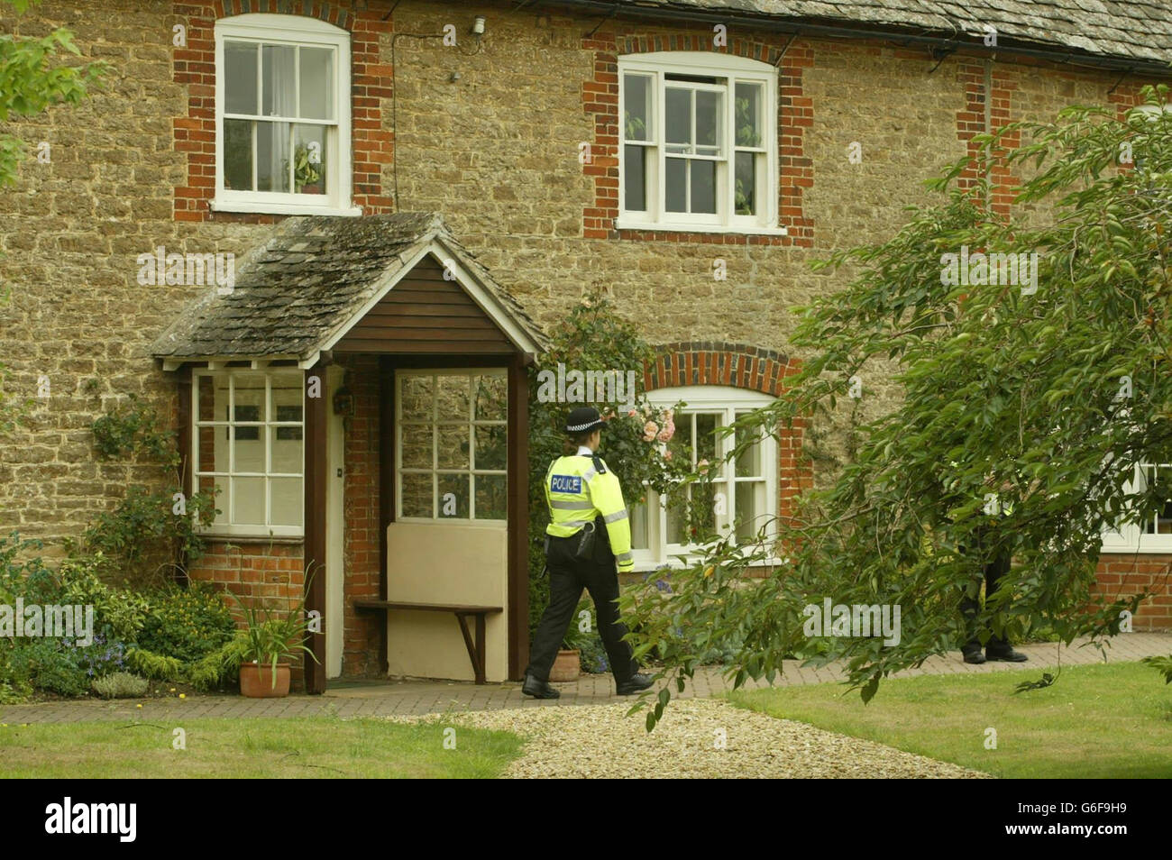 A police officer stands outside the Southmoor home of Dr David Kelly, who is thought to be the Ministry of Defence mole who briefed BBC journalist Andrew Gilligan about the build-up to the Gulf War, after he went missing yesterday. * A man's body has been found at nearby Harrowdean Hill. Stock Photo