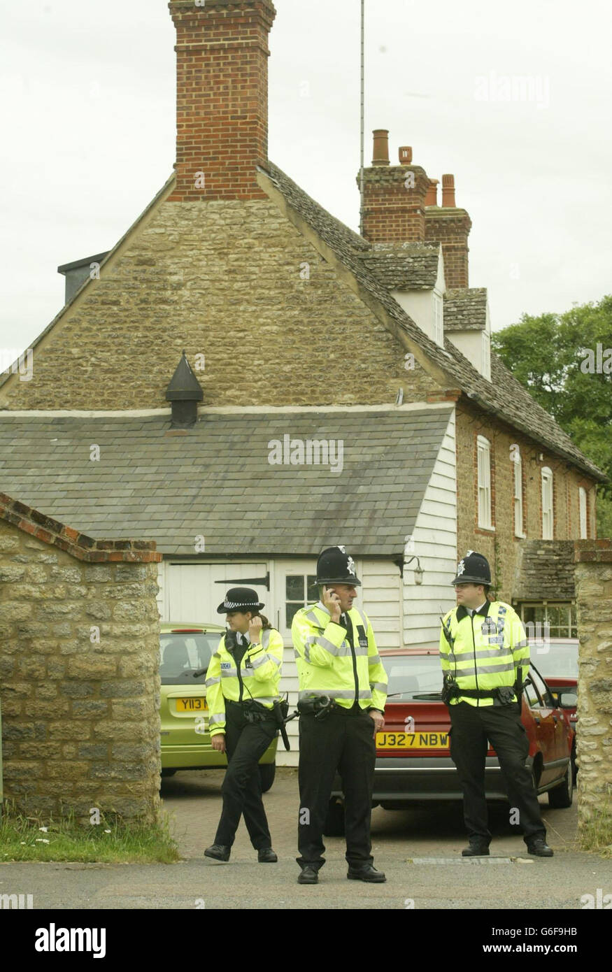 Police officers stand outside the Southmoor home of Dr David Kelly, A Ministry of Defence official at the centre of a row about a Government dossier on weapons of mass destruction, who went missing yesterday. A man's body has been found at nearby Harrowdean Hill. Stock Photo