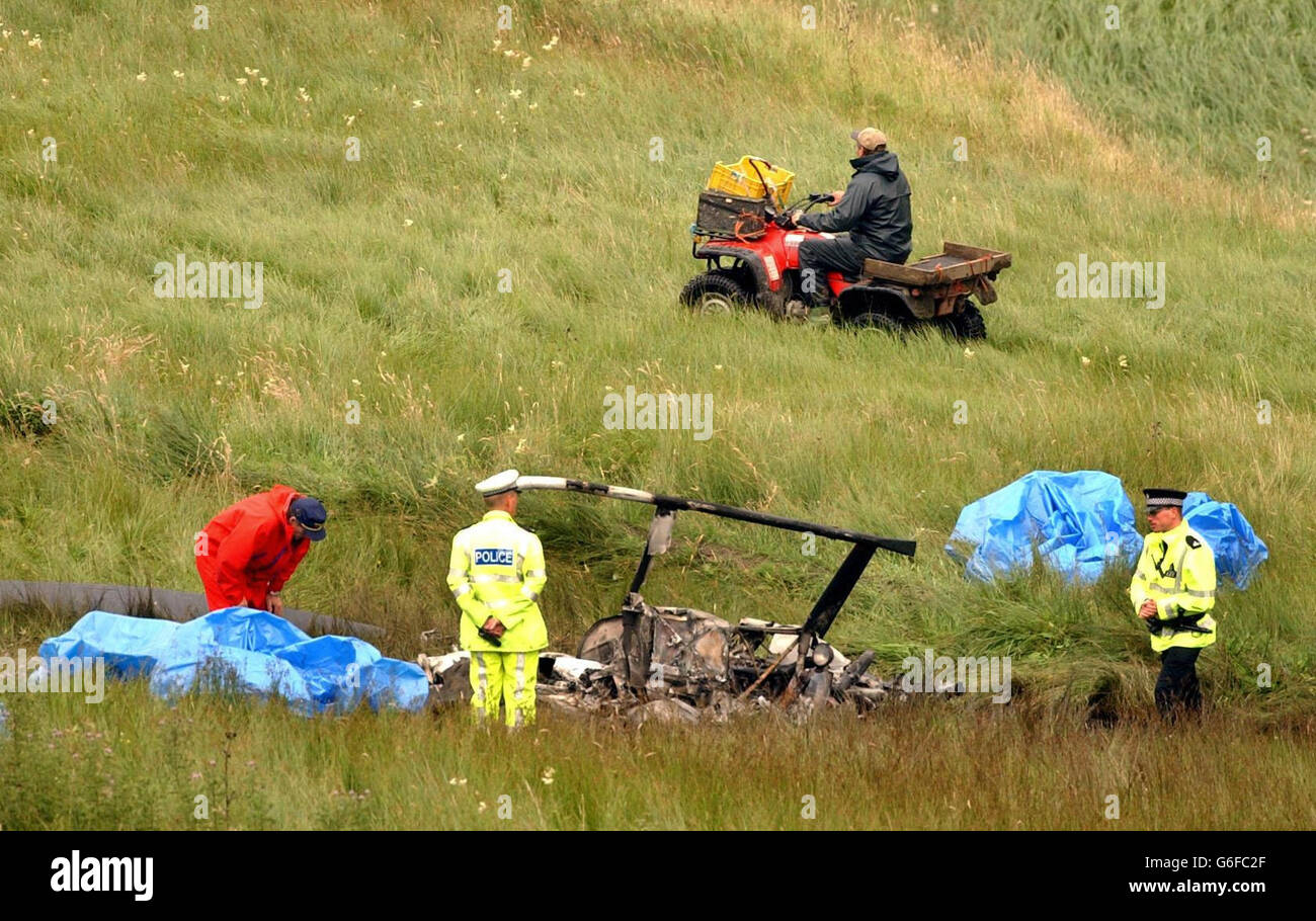 Police view the site of a helicopter crash which claimed the life of British Superbike champion Steve Hislop, near Hawick in the Scottish Borders. The 41-year-old motorsport star was alone when the aircraft came down yesterday on farmland. *310703* Stock Photo