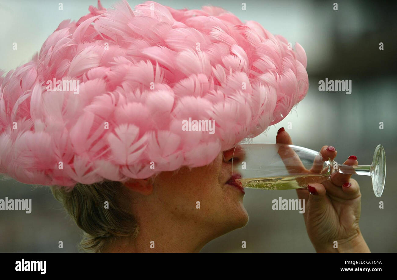 Goodwood racing. Goodwood member Joy Rudge enjoys a glass of champagne on Ladies Day at the horse racing track near Chichester, West Sussex. Stock Photo