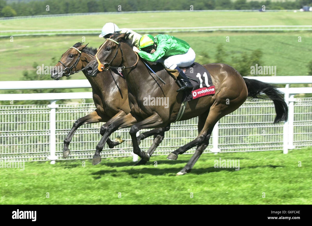 Moments of Joy (R) ridden by Seb Sanders wins The Vodafone EBF Fillies' Stakes at Goodwood from Discreet Brief ridden by Pat Eddery. Stock Photo