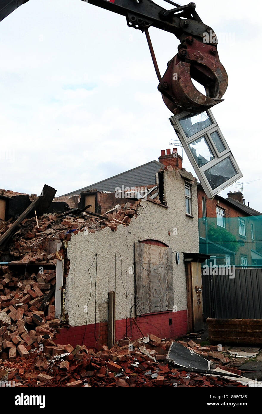 Demolition work begins on Mick and Mairead Philpott's old family home on Victory Road, Derby, where the two parents set a deadly fire which killed their children. Stock Photo