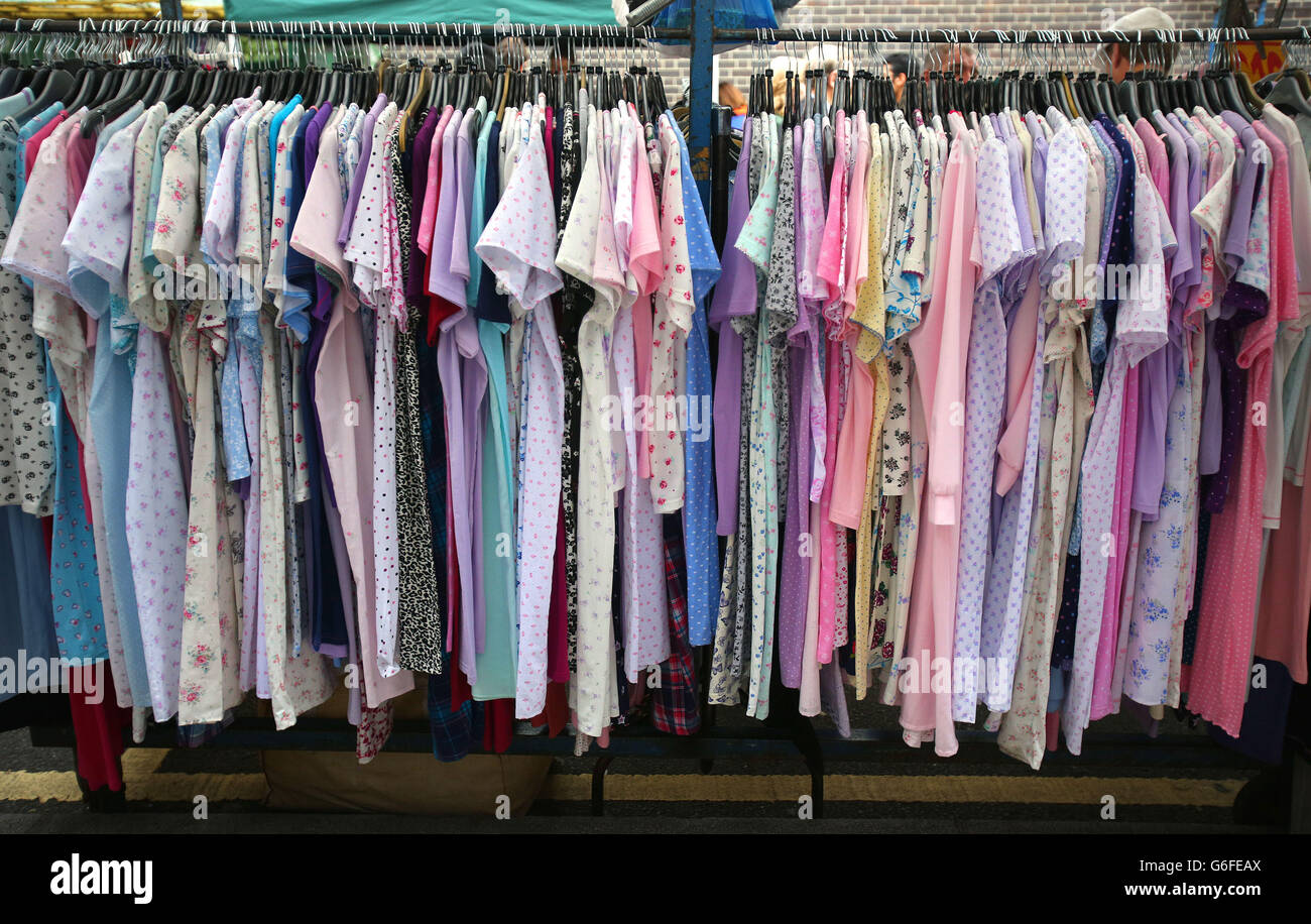 Clothes for sale on a stall in Leather Lane market, London Stock Photo
