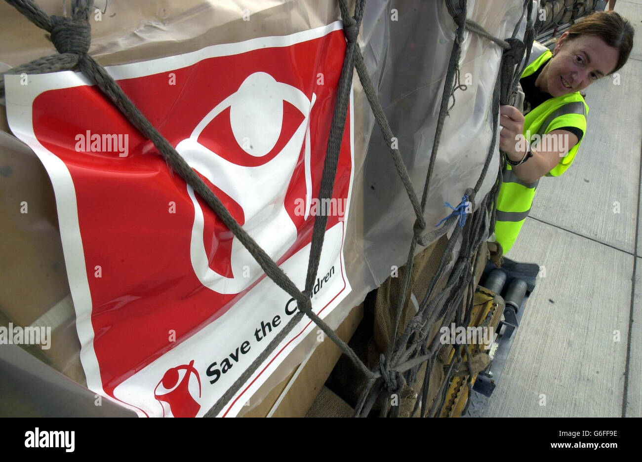 Sheila Boswell, from Save the Children, checks pallets before they are loaded onto a plane at Manston airport in Kent, bound for Liberia in West Africa. Conditions in the Liberian capital were appalling, Oxfam said, with as many as 10 families displaced by fighting living in one hut no larger than the average bedroom. Many at the city s displacement camps had to wait for fierce shooting to subside before making perilous runs for clean water. Stock Photo