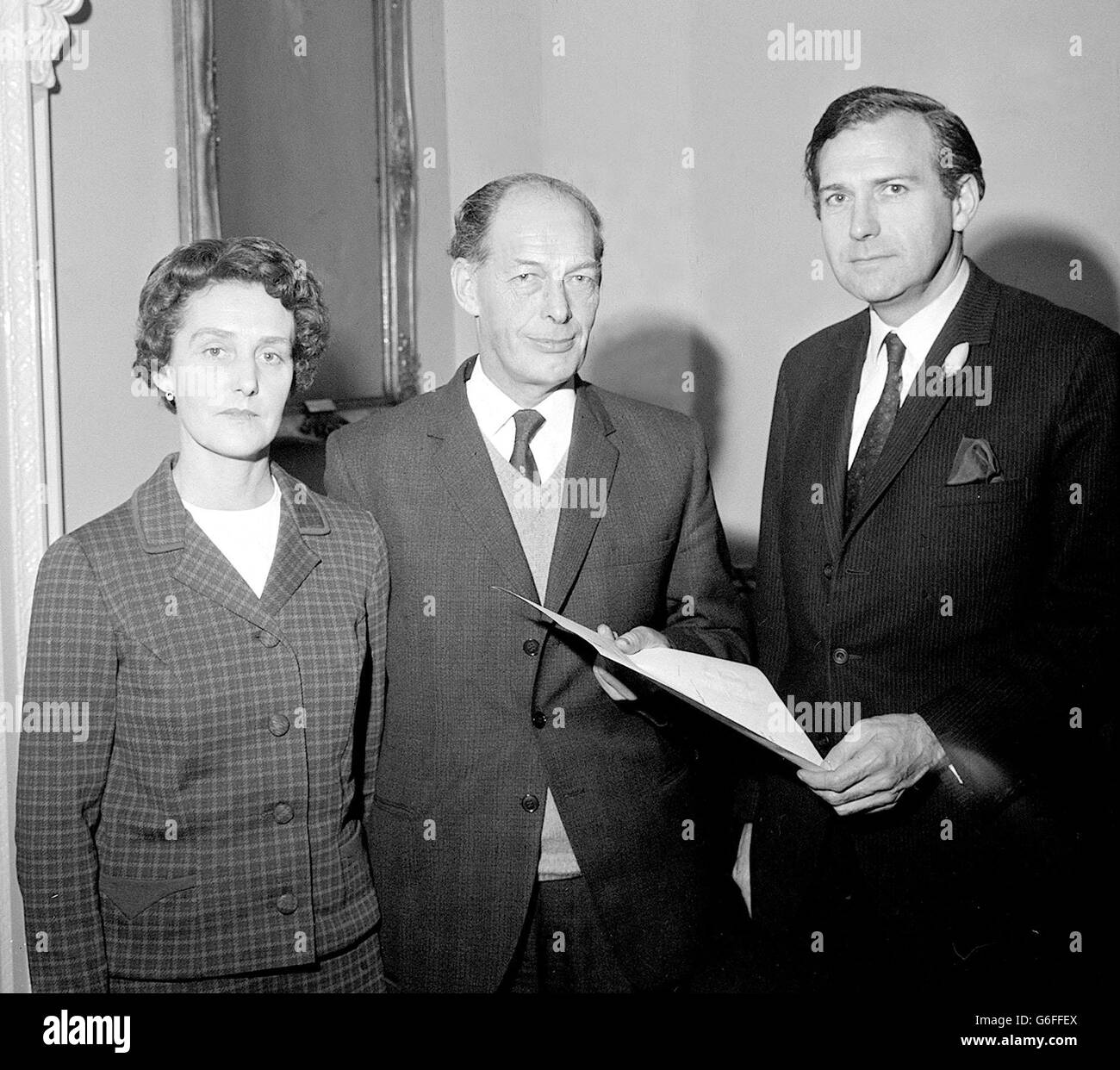 Mr Alfred Hall, 50-year-old Bournemouth postman, with his wife and the Postmaster General, John Stonehouse after receiving 30 and an engraved wallet for his courage in attempting to prevent three armed assailants from robbing a mailvan. The presentation was made at the GPO, London. Stock Photo