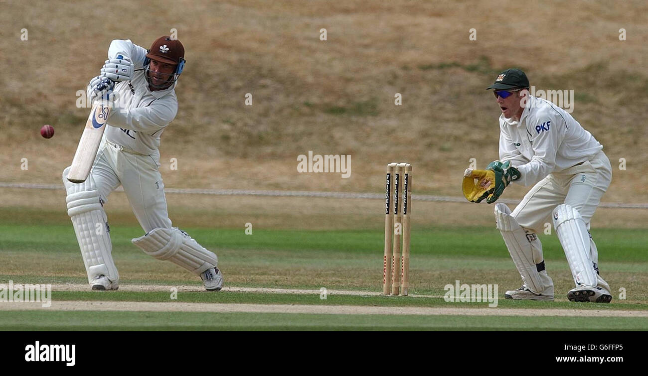 Surrey batsman Graham Thorpe hits the ball for 4 runs, watched by Nottinghamshire wicketkeeper Chris Read, during the Frizzell County Championship match against Nottinghamshire at Whitgift School grounds, Croydon. Stock Photo