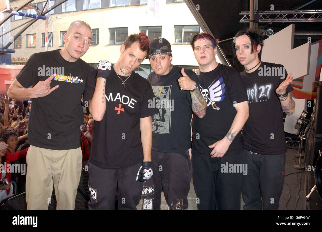 Rock group Good Charlotte (l-r) Chris Wilson, Joel Madden, Benji Madden, Paul Thomas, and Billy Martin pose for the media during the live recording of the British edition of MTV's TRL (Total Request Live) at MTV's Studios in Camden, north London. Stock Photo