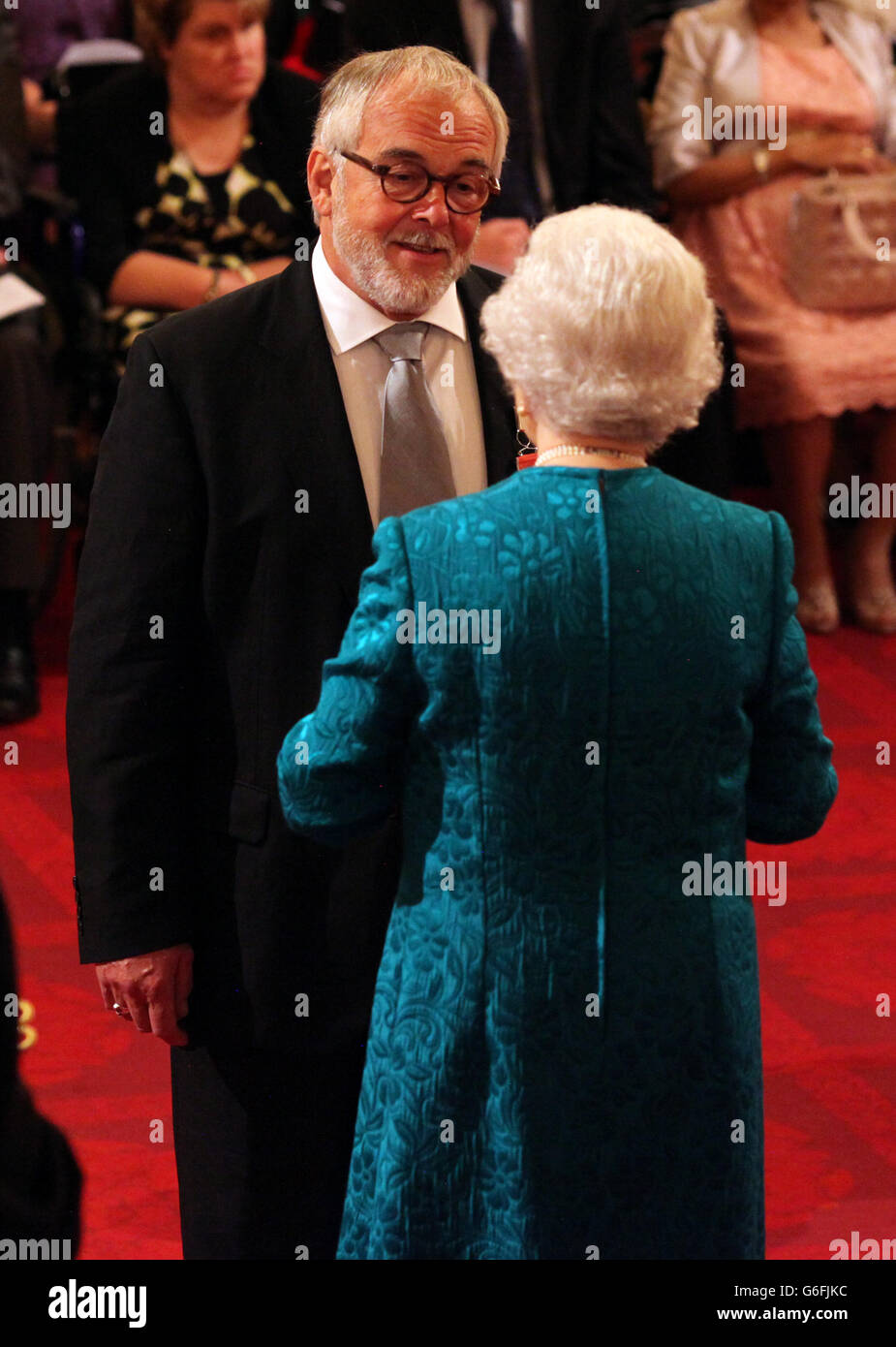 David Ellis receives an OBE from Queen Elizabeth II at an Investiture ...