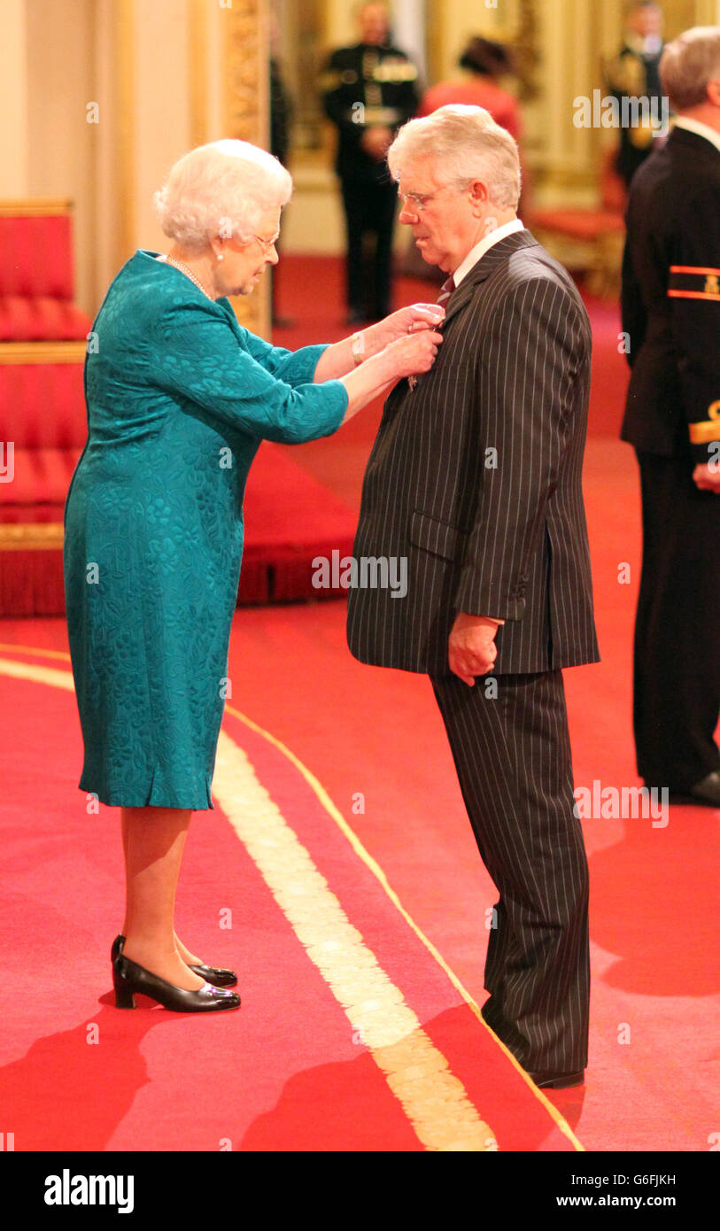 John Bancroft receives an MBE from Queen Elizabeth II at an Investiture