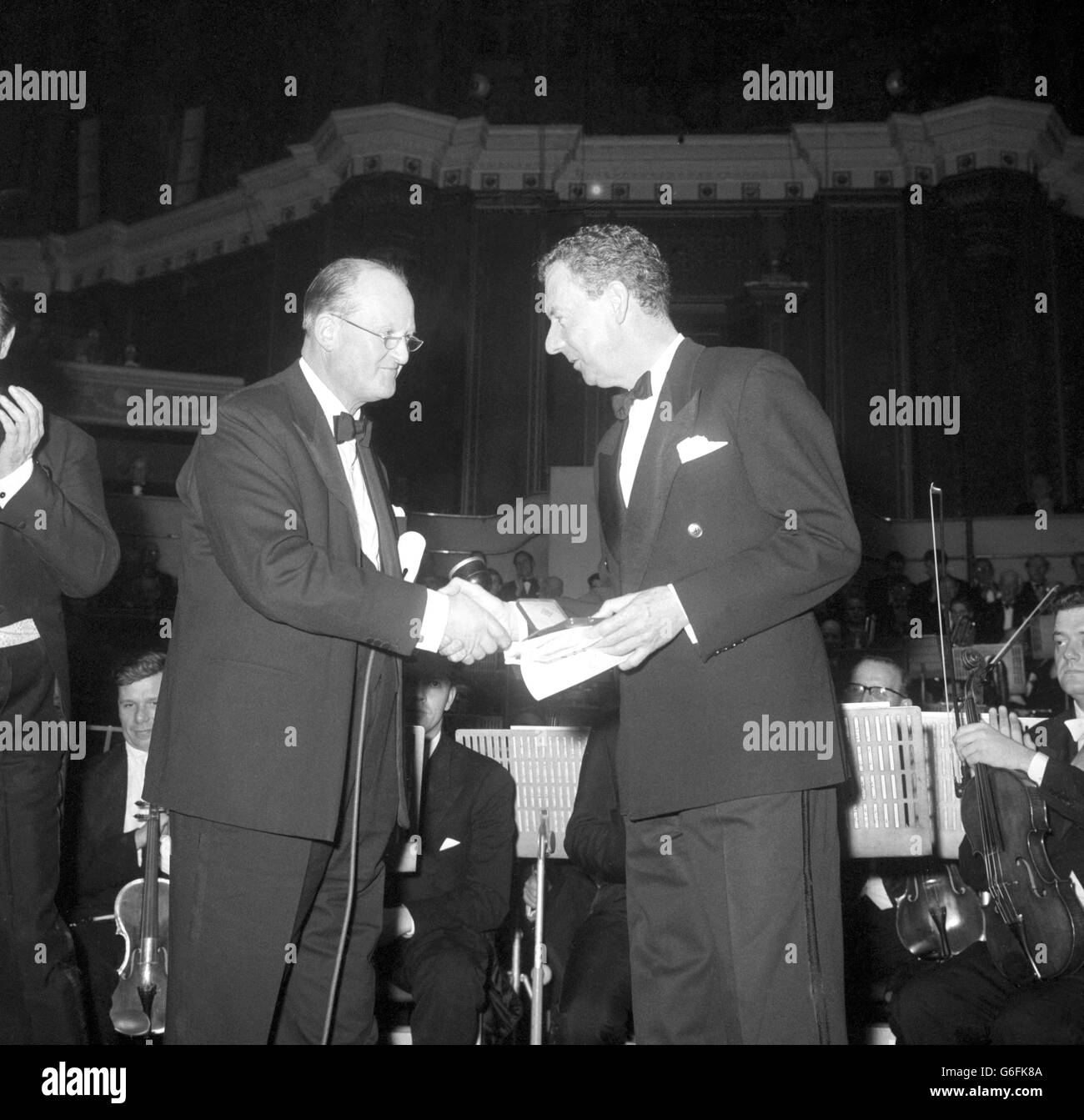 Composer Benjamin Britten receives the Gold Medal of the Royal Philharmonic Society from Sir Thomas Armstrong at the Royal Albert Hall. Stock Photo