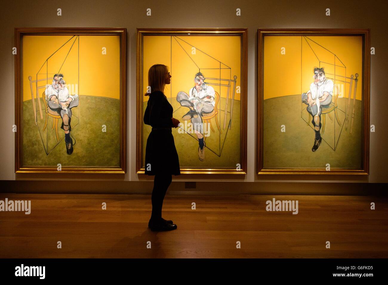 A visitor views 'Three Studies of Lucian Freud', by Francis Bacon, at Christie's, in central London. Stock Photo