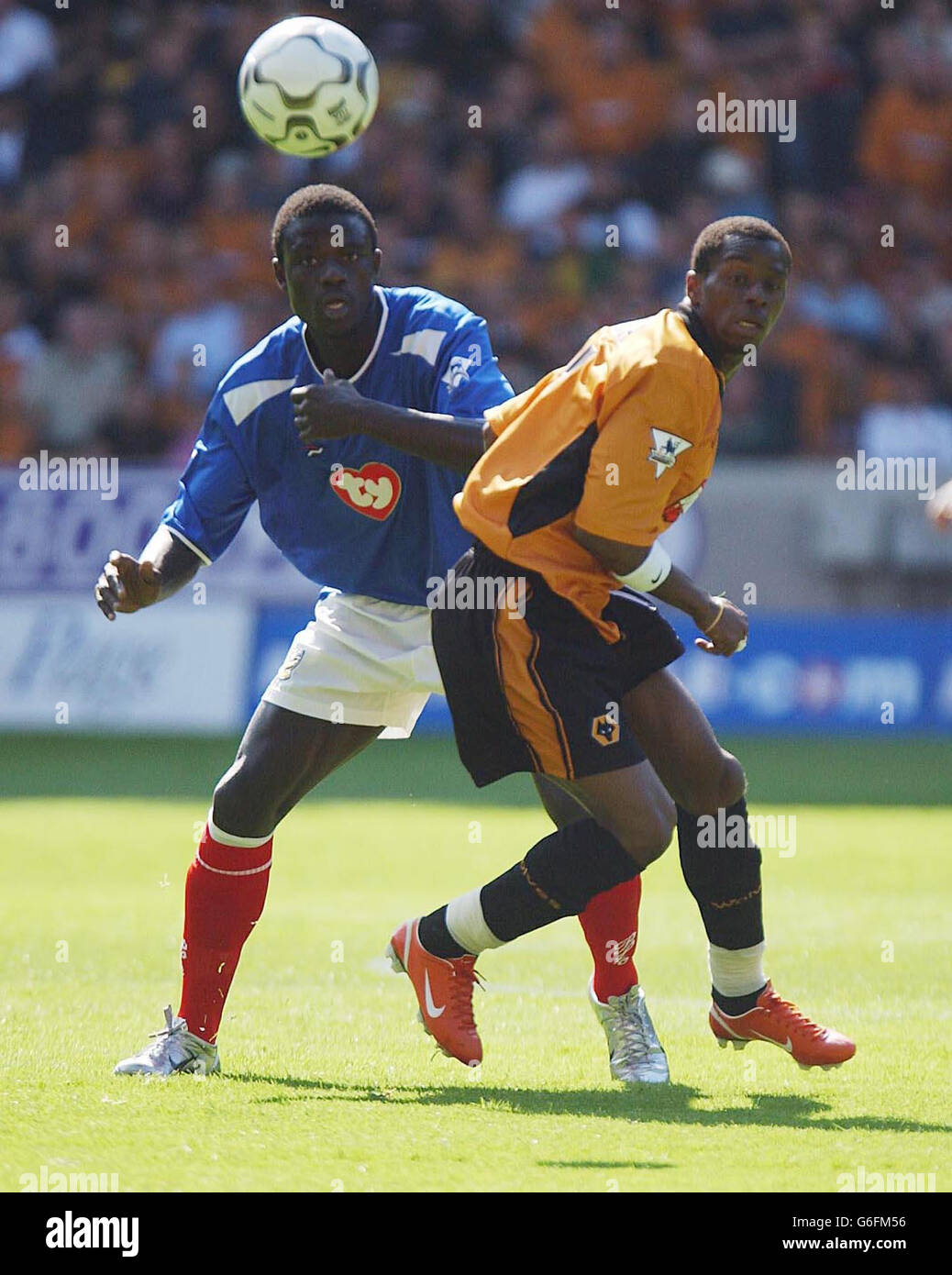 Portsmouth defender Amdy Faye battles with Wolverhampton Wanderers Henri Camara (R), during their FA Premiership match at Wolves' Molineux ground. Stock Photo