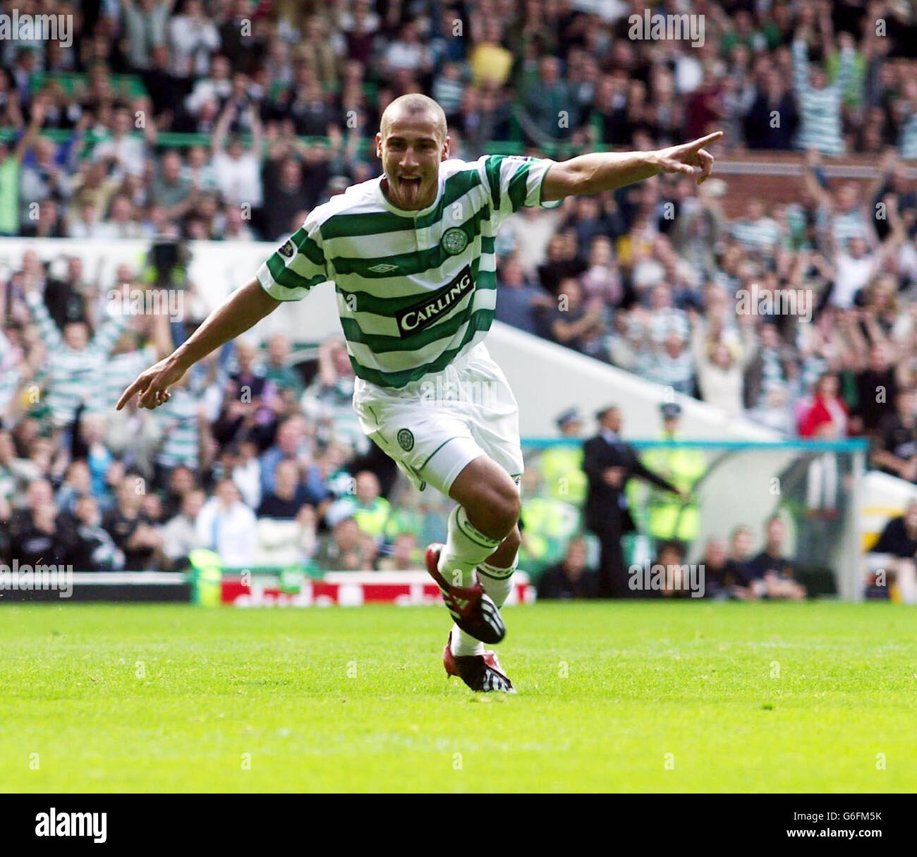 Celtic s Henrik Larsson celebrates his goal against Livingston