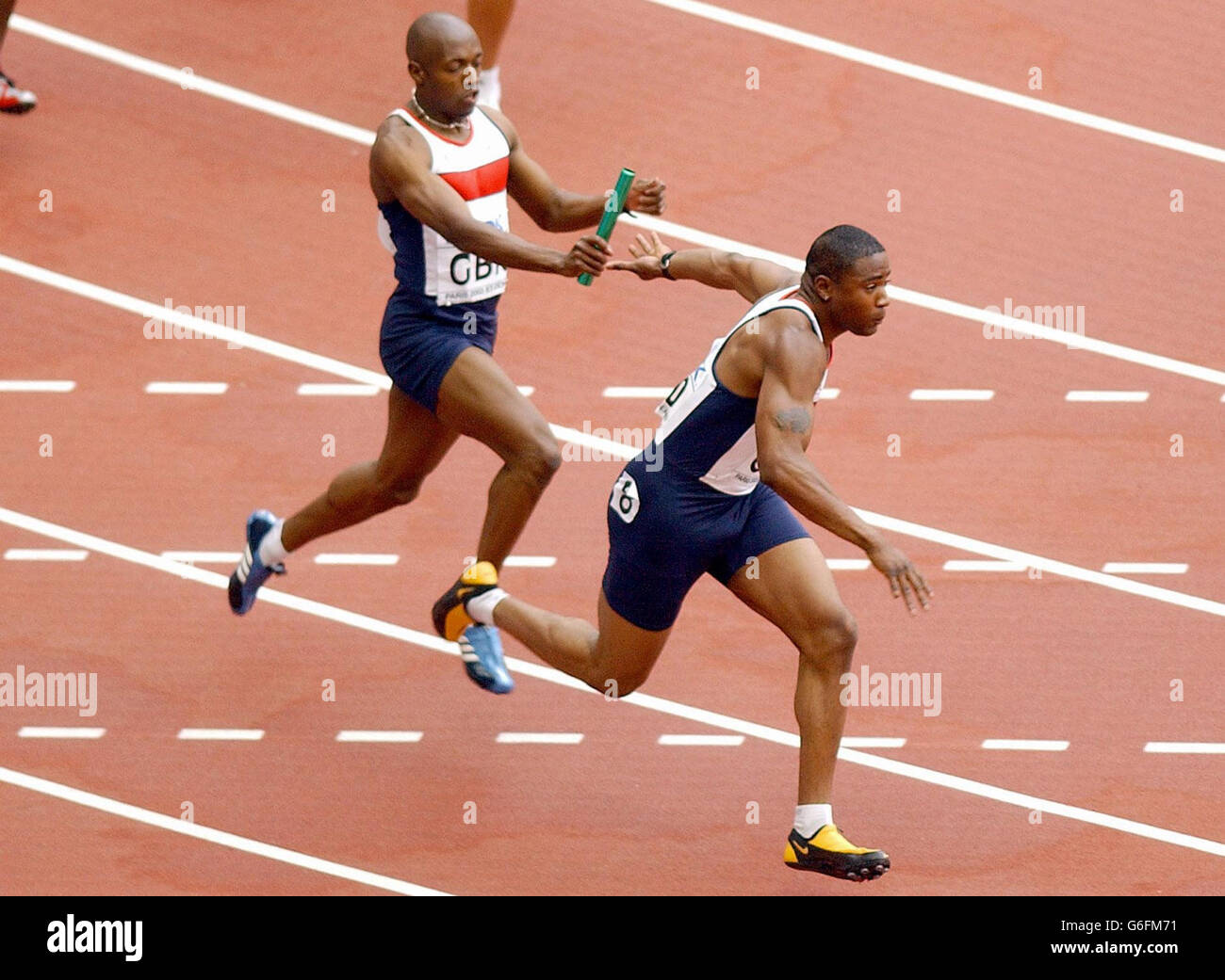 Mark Lewis Francis (right) takes the baton from Marlon Devonish to give the Great Britain 4x100 relay Team an easy first round victory in their event at the Athletics World Championships in Paris. Stock Photo