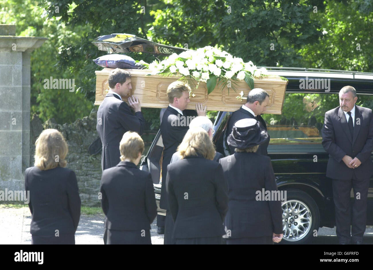The coffin of Dr David Kelly is carried by family members as his wife and three daughters look on at St Mary's Church in Longworth, Oxfordshire. A private funeral was being held today for the government weapons expert at St Mary's Church, overlooking the spot where the doctor is believed to have committed suicide. Around 160 mourners were expected to join the family of Dr Kelly at the funeral. Stock Photo