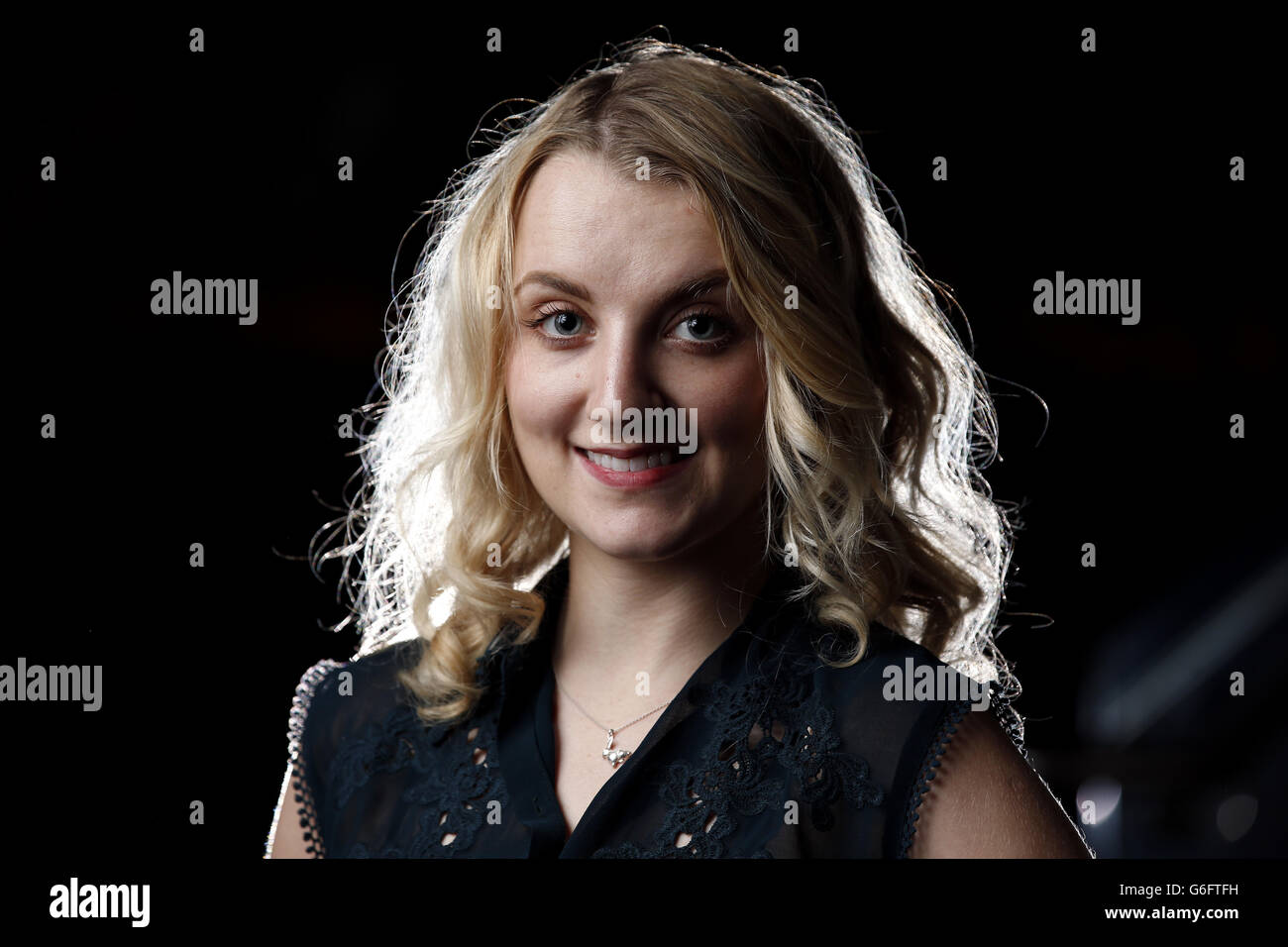 Evanna Lynch, who played Luna Lovegood in the Harry Potter films, and who is currently touring in a new play about the life of Harry Houdini, playing his wife, models a pair of handcuffs at Leicester Square's Hippodrome which Houdini used in one of his most famous escape routines. Stock Photo