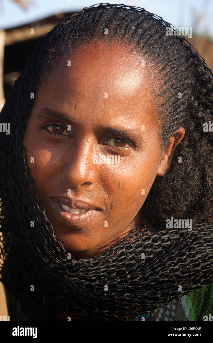 Portrait of an Oromo mother with child with scarification and stylised hair. Oromia Zone, Amhara Region, Ethiopia Stock Photo