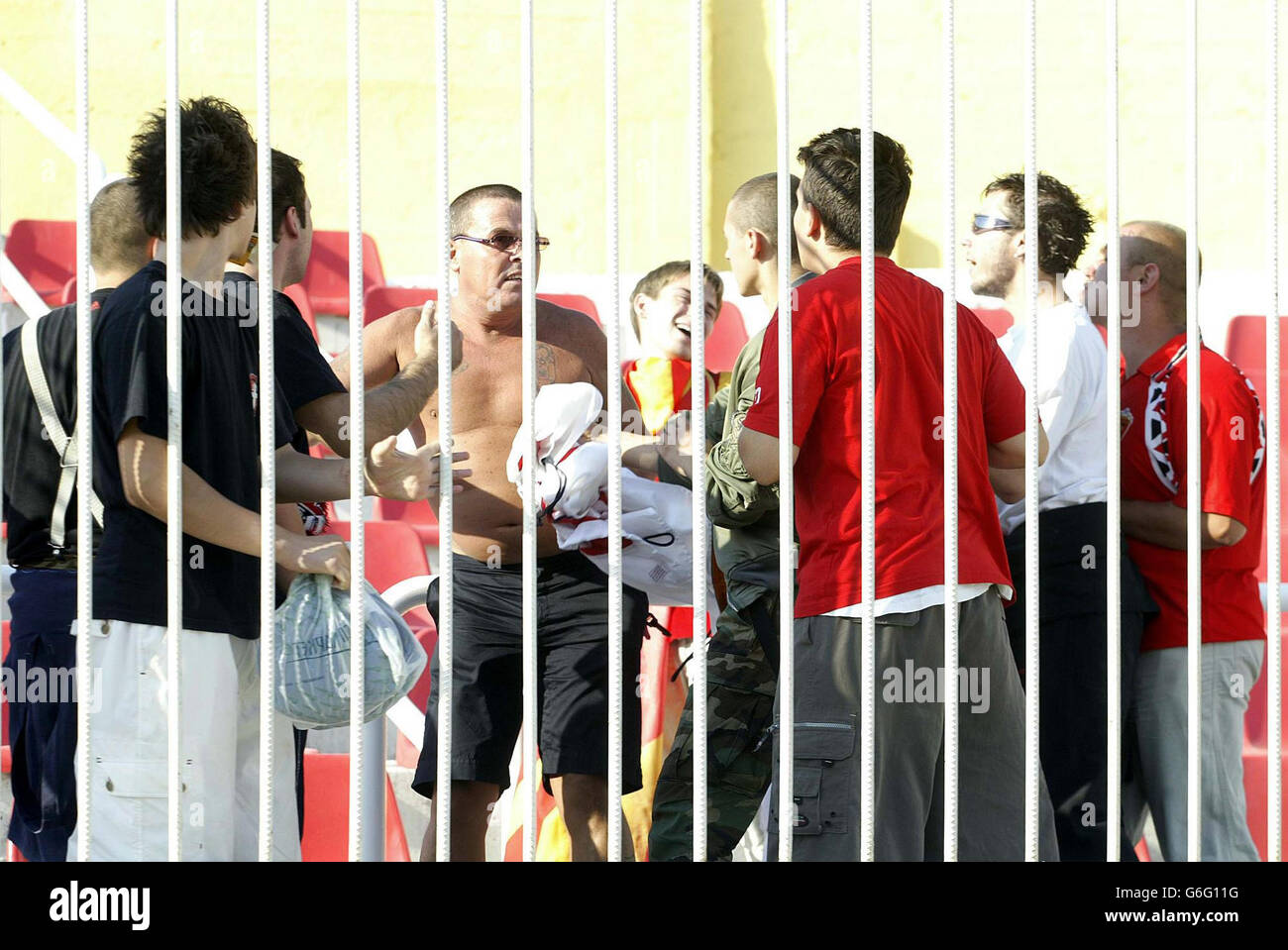 An England fan (centre left) is confronted by Macedonian fans before