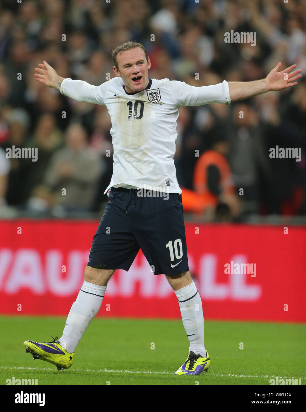 England's Wayne Rooney celebrates scoring his side's first goal of the game during the FIFA 2014 World Cup Qualifying, Group H match at Wembley Stadium, London. Stock Photo