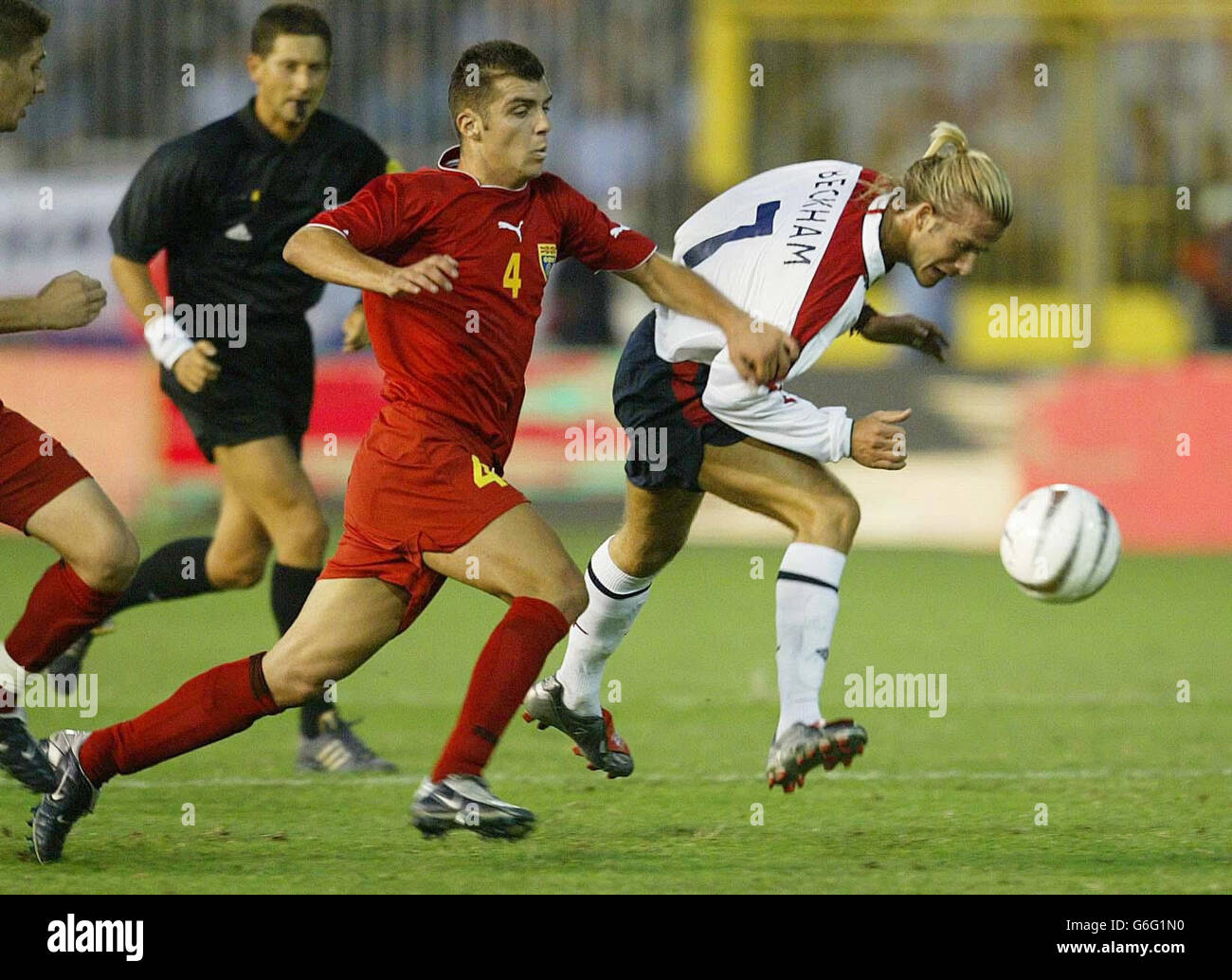 Macedonia's Pandev Goran (L) challenges England captain David Beckham during their group seven Euro 2004 qualifying match at The City Stadium, Skopje, Macedonia. Stock Photo