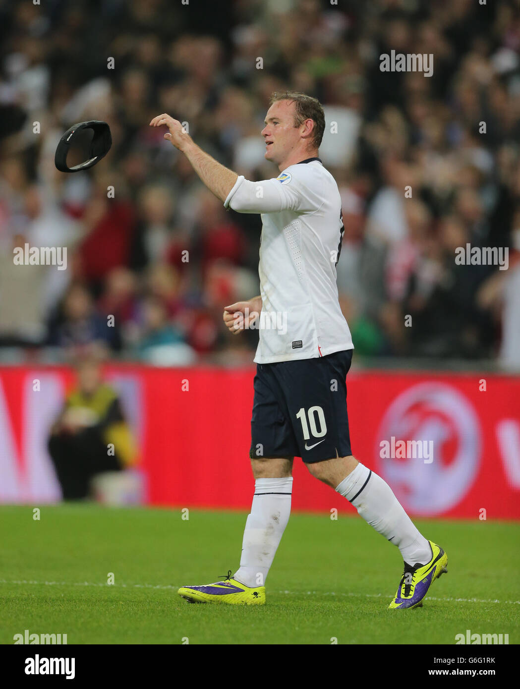 England's Wayne Rooney throws his headband following their victory over Poland in the FIFA 2014 World Cup Qualifying, Group H match at Wembley Stadium, London. PRESS ASSOCIATION Photo. Picture date: Tuesday October 15, 2013. England have qualified for next year's World Cup in Brazil after winning their final qualifying Group H match against Poland 2-0. See PA story SOCCER England. Photo credit should read: Nick Potts/PA Wire. RESTRICTIONS: Use subject to FA restrictions. Editorial use only. Commercial use only with prior written consent of the FA. No editing except cropping. Call +44 (0)1158 Stock Photo