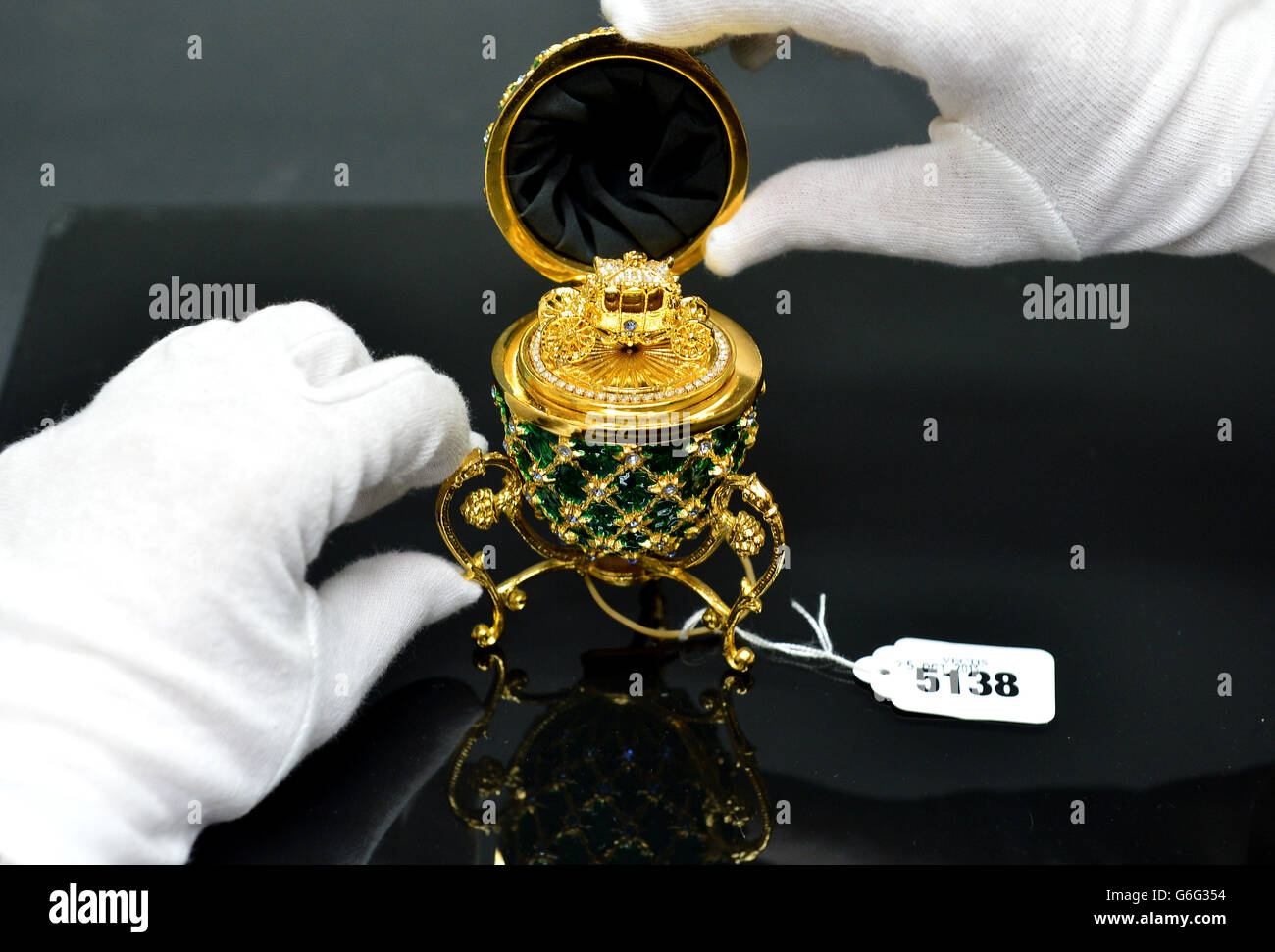 A Swarovski fine detailed replica prop of a Faberge Egg taken from the  James Bond film"Octopussy", finished in 22 carat gold and encrusted with 96  Swarovski crystals which is to be auctioned