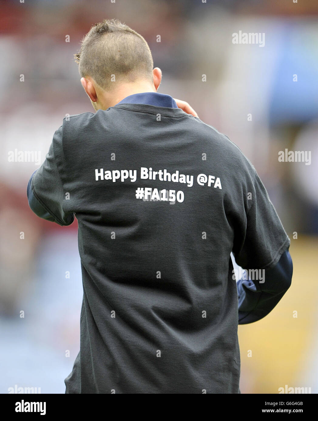 A football player wears a shirt with ‘Happy Birthday @FA #FA150’ on the