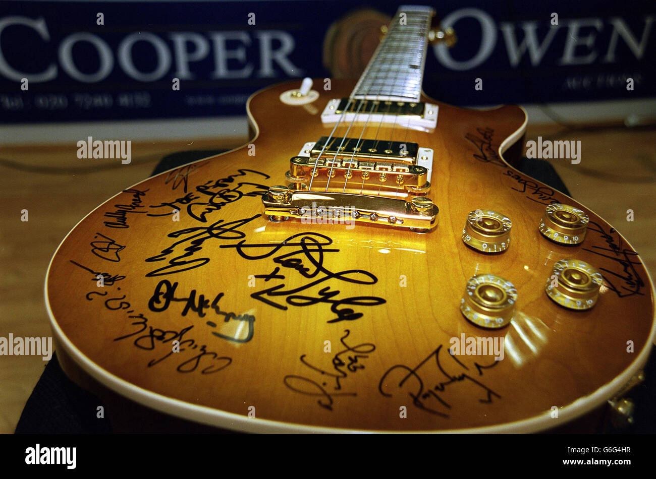 A 1996 Gibson Les Paul standard guitar signed and played for over a year by Jimmy Page a former member of Led Zeppelin. The Guitar which is also signed by many big name artists including Steve Tyler from Aerosmith, Alice Cooper and the Sterophonics, is being auctioned tomorrow in aid of the ABC Trust, along with other rock memorabilia including and early Jim Morrison poem and one of David Bowies contracts. Stock Photo