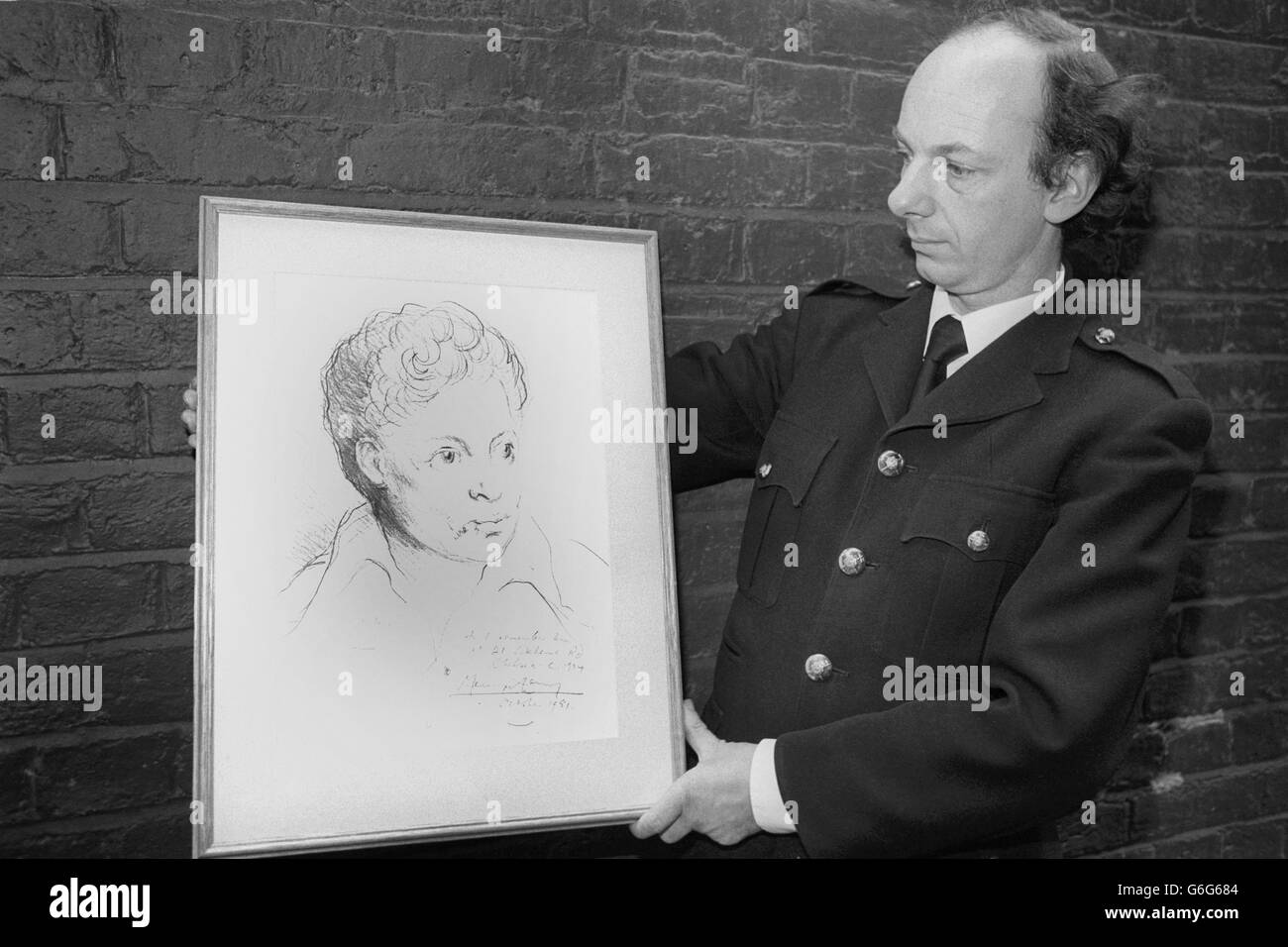An usher at the Duke of York's Theatre, London, holds Mervyn Levy's portrait of the late Welsh poet Dylan Thomas. It is due to be auctioned at the theatre by Sir Huw Wheldon during the Dylan Thomas Celebration Concert to raise funds for the installation of a plaque to Dylan Thomas in Poets Corner at Westminster Abbey. Stock Photo