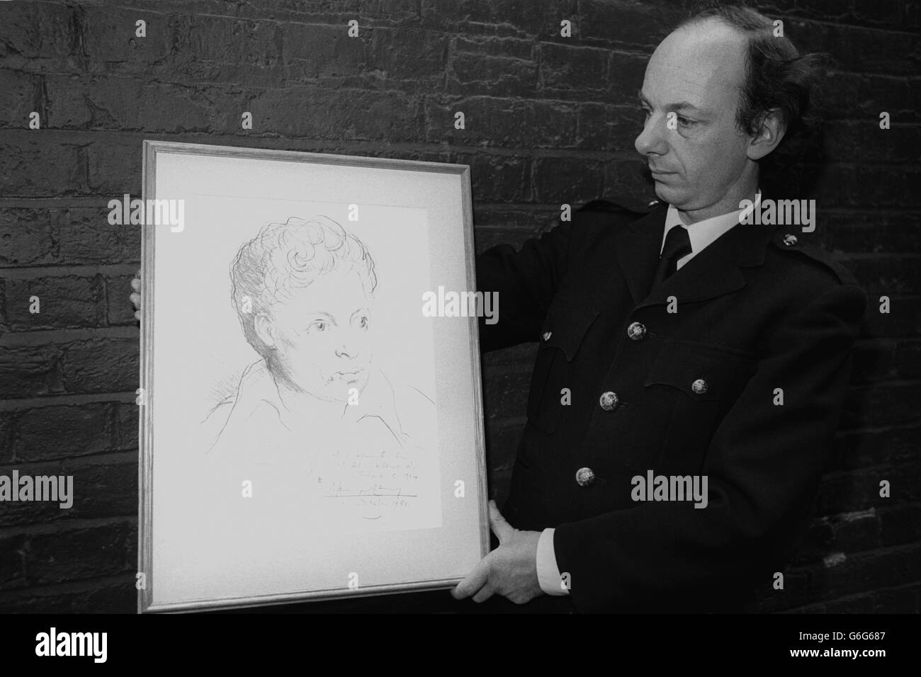 An usher at the Duke of York's Theatre, London, holds Mervyn Levy's portrait of the late Welsh poet Dylan Thomas. It is due to be auctioned at the theatre by Sir Huw Wheldon during the Dylan Thomas Celebration Concert to raise funds for the installation of a plaque to Dylan Thomas in Poets Corner at Westminster Abbey. Stock Photo