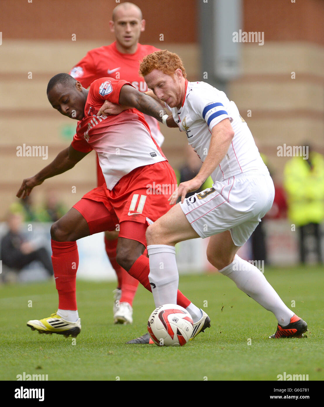 Leyton Orient's Moses Odubajo (left) battles for the ball with MK Dons' Dean Lewington during the Sky Bet League One match at the Matchroom Stadium, London. Stock Photo