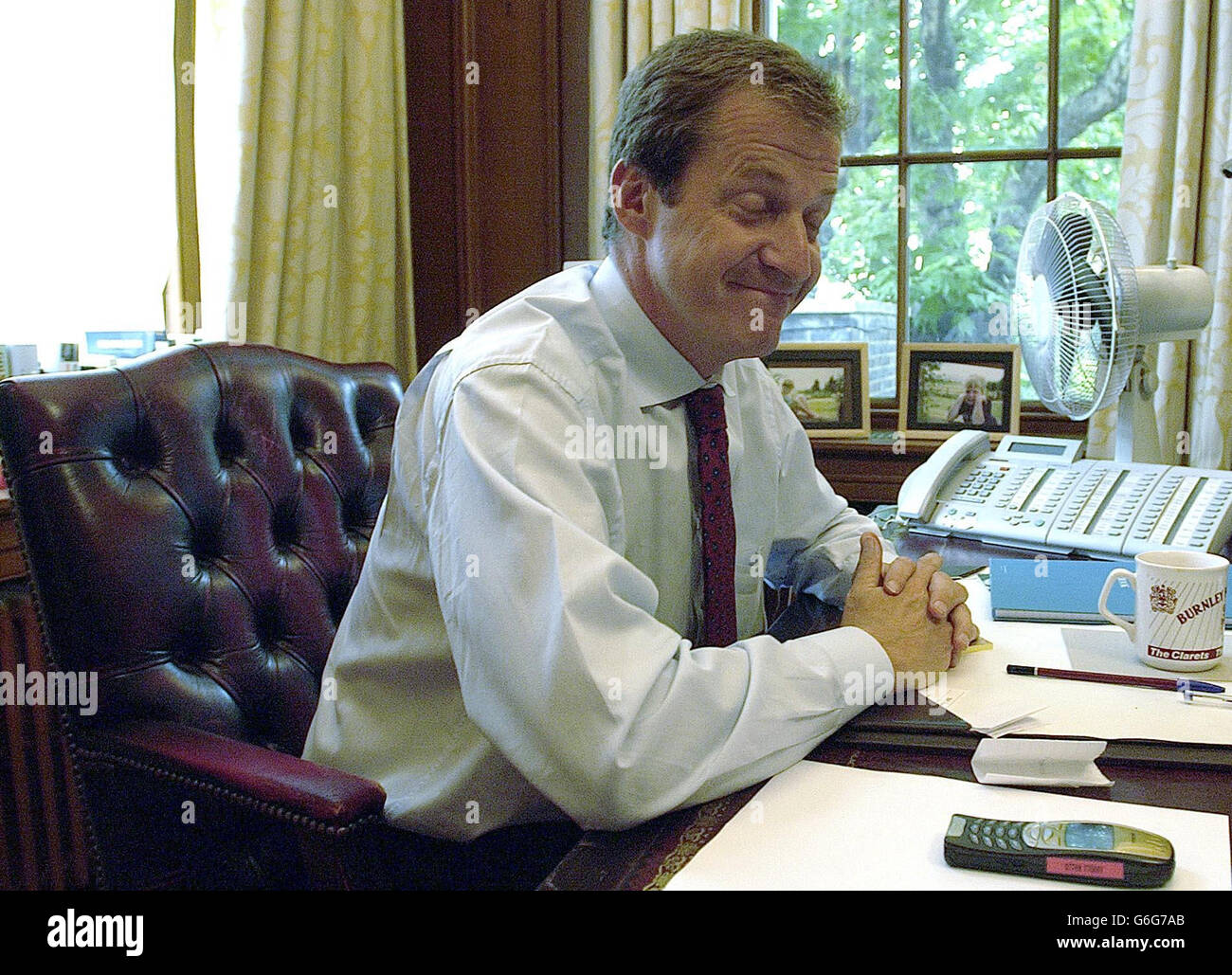 Alastair Campbell in his office in Downing Street after announcing his resignation as Director of Communications to Prime Minister Tony Blair, in London. Blair's top aide announced his resignation on Friday in a shock decision that comes amid the worst crisis of the British premier's six-year rule. Stock Photo