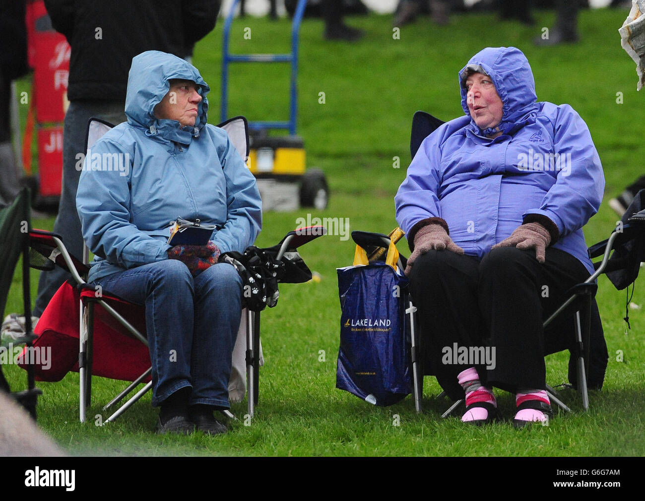 Racegoers wrap up against the cold, damp conditions during day two of the October Finale 2013 meeting at York Racecourse, York. Stock Photo