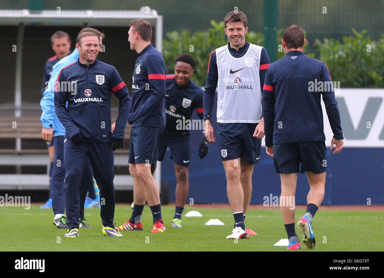 England's Wayne Rooney shares a joke with James Milner and Michael Carrick after Phil Jagielka was cut on the face by accident, during training at London Colney, Hertfordshire. Stock Photo