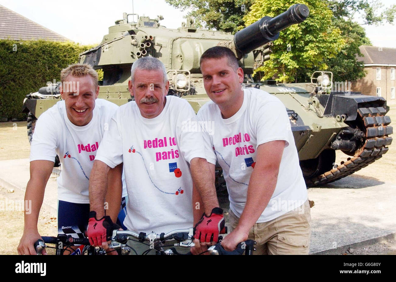 Curly Turrington (centre), 54, from Cambridge, who's son was killed while serving in Iraq earlier this year, poses at Bassingbourn Barracks in Hertfordshire with his colleagues Jamie Lidlow (left) and Captain Adam Briggs, on the bicycles they intend to ride to Paris this week to help raise money for the Royal British Legion. Mr Turrington, who works at the Barracks, will make the journey in memory of his son Kelan who was killed in action in Basra in April. Stock Photo