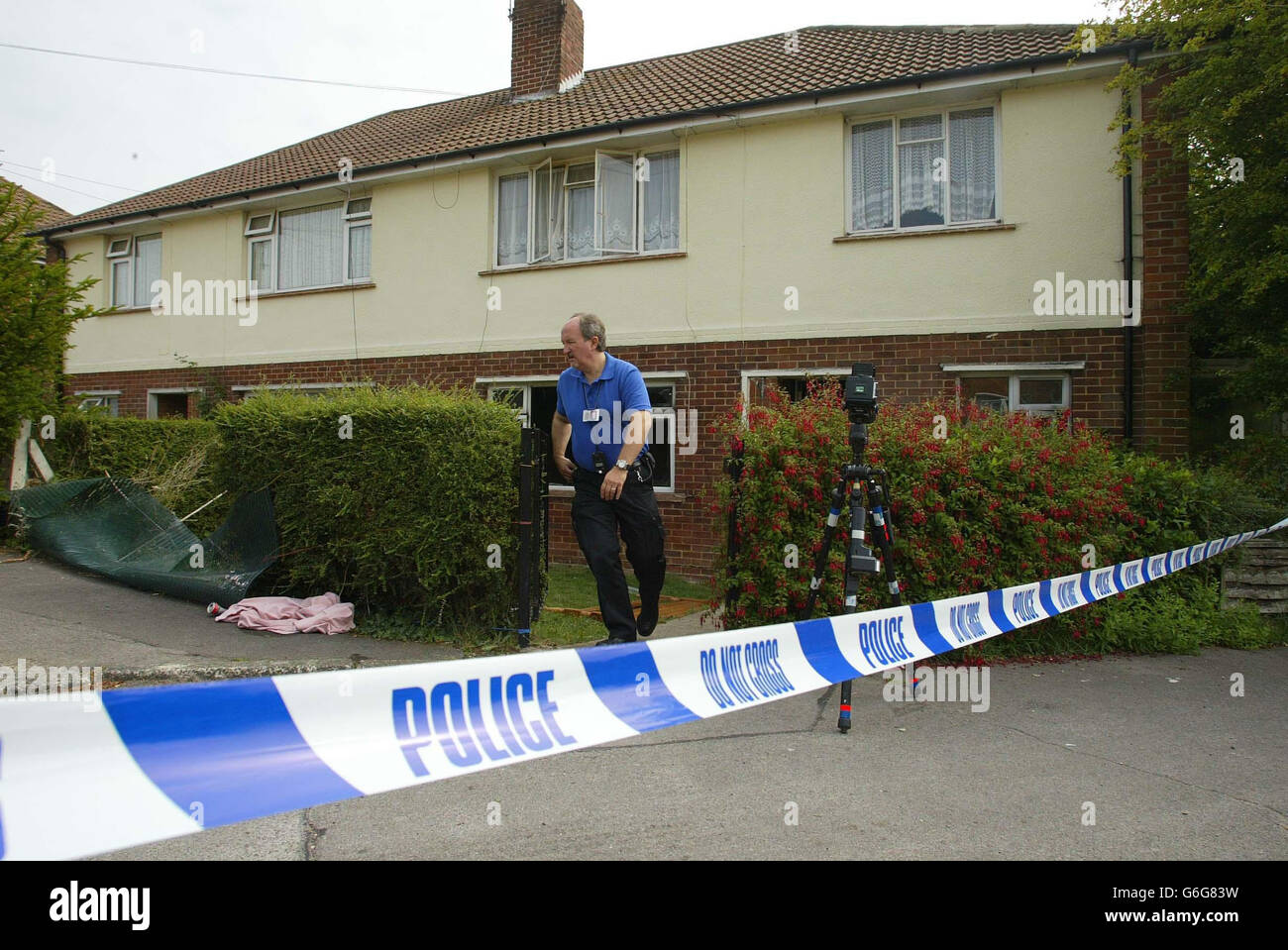 A Police officer stands outside the house near Fareham, Hampshire, where a five year old boy died and his three-and-a-half-year-old brother was seriously injured in a house fire. Neighbours and the children's father were unable to rescue the youngster as the blaze engulfed their ground floor maisonette at about 9am. Stock Photo