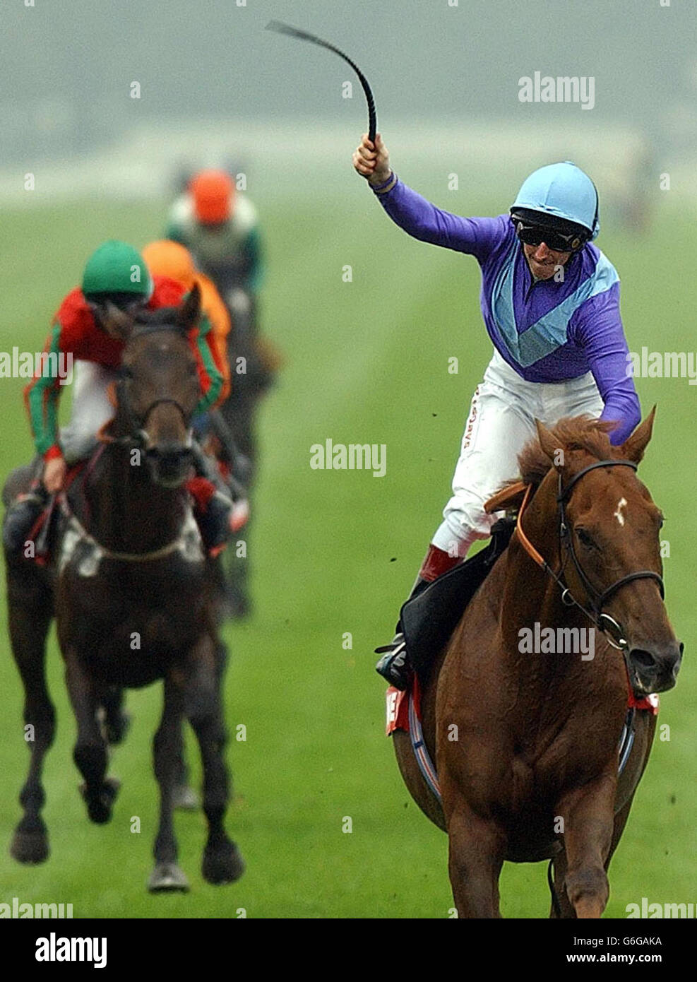 Martin Dwyer celebrates as he crosses the line on Persian Punch to win