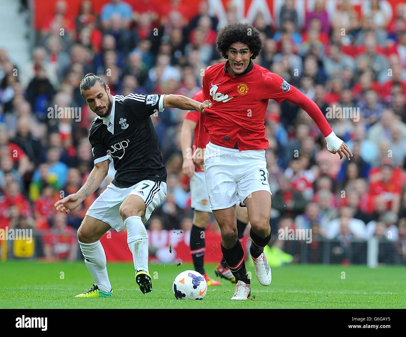 Southampton's Pablo Osvaldo (left) and Manchester United's Marouane Fellaini battle for the ball Stock Photo
