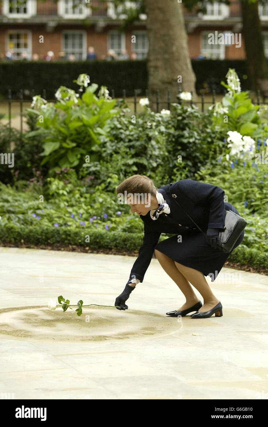 The Princess Royal lays a single rose at the memorial garden in Grosvenor Square, London, dedicated to the memory of those who died when two hijacked passenger jets that crashed into the twin towers of New York's World Trade Center. * The garden of remembrance contains a small pavilion bearing three bronze plaques, listing the names of victims for the UK, UK Overseas Territories and those with dual nationalities. Stock Photo