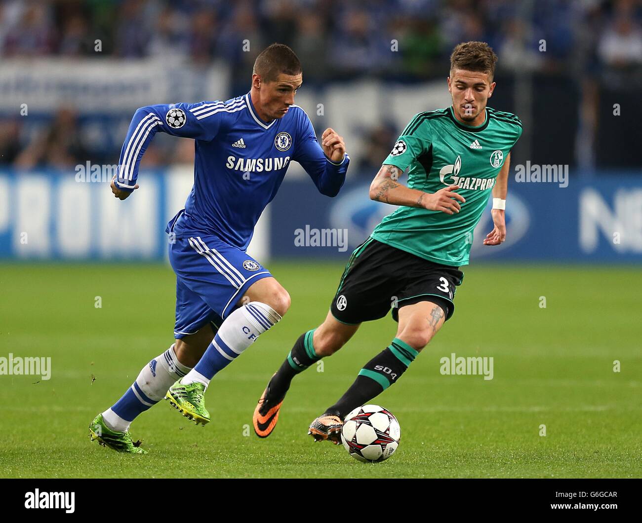 Soccer - UEFA Champions League - Group E - Schalke 04 v Chelsea - Veltins-Arena. Chelsea's Fernando Torres (left) and Schalke 04's Roman Neustadter in action Stock Photo