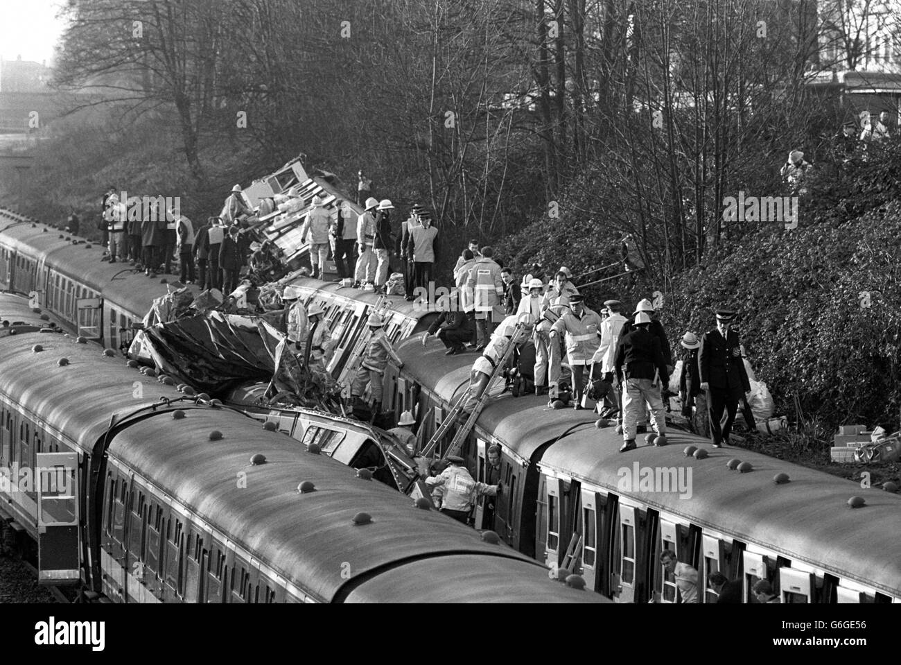 Rescue workers clamber over the wreckage of three trains that crashed near Clapham Junction, London, to help injured passengers following a multiple train crash in which 35 people were killed and 500 were injured when a crowded passenger train crashed into the rear of another train that had stopped at a signal, and an empty train, travelling in the other direction, crashed into the debris. Stock Photo
