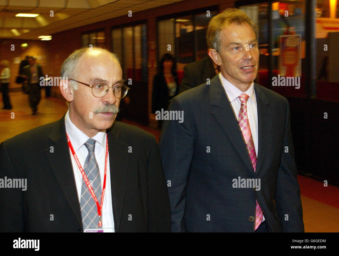 Prime Minister Tony Blair leaves the health debate with his director of communications David Hill at the Labour Party Conference in Bournemouth. Mr Blair suffered an embarrassing defeat on foundation hospitals today when delegates voted to scrap his flagship policy at the conference. The Prime Minister will push ahead with the controversial plan to give greater freedom to top hospitals, but the defeat will give fresh ammunition to Labour MPs fighting the reforms in the House of Commons. Stock Photo