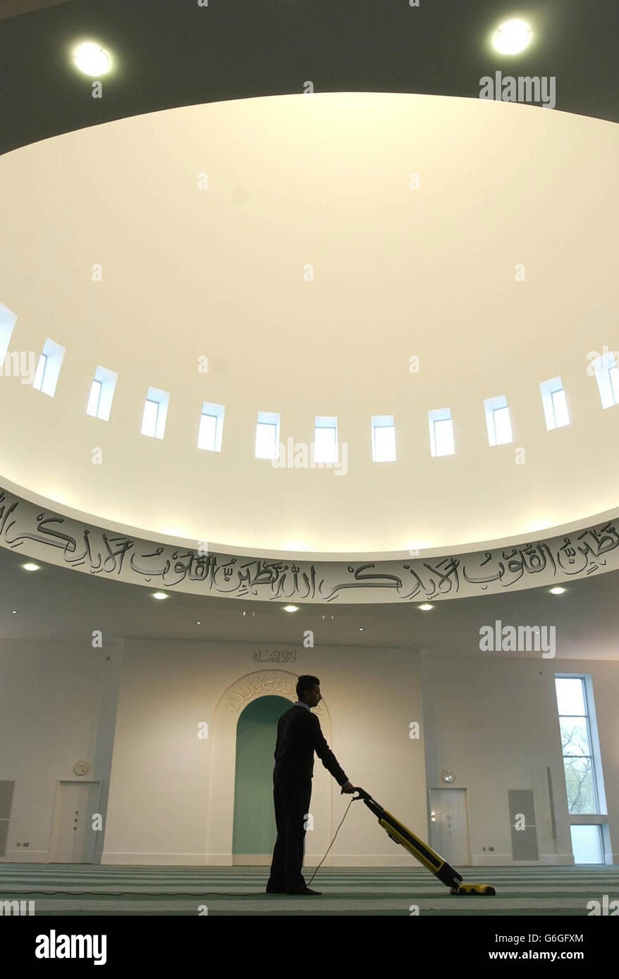 Final preparations are carried out in the main prayer room at the Baitul Futuh Mosque in Morden, south London, ahead of an inaugauration ceremony for the religious centre. * The mosque, the largest in Western Europe, can hold up to 10,000 worshippers and was built at a cost of 15 million by Britain's Ahmadi Muslims, who opened London's first mosque nearly 80 years ago. British devotees of the community will be joined by representatives from countries worldwide, including the worldwide supreme head of the community, Hadhrat Mirza Masroor Ahmad, at the ceremony. Stock Photo