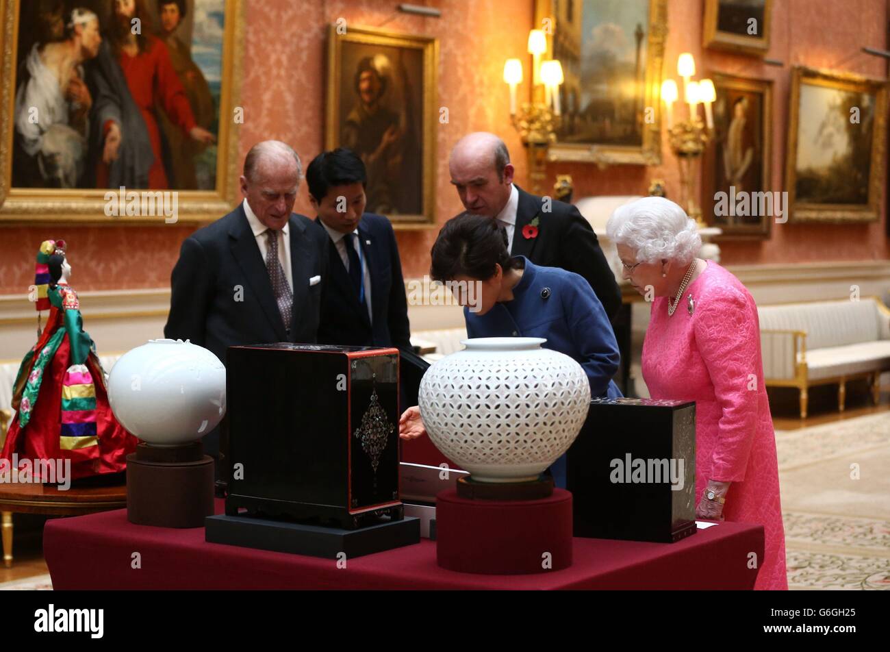 The President of the Republic of Korea Park Geun-Hye (second right), the Duke of Edinburgh (left) and Queen Elizabeth II (right) look on at an exhibition of Korean related items from the Royal Collection and Royal Archives in the Picture Gallery of Buckingham Palace in London. The President is on a state visit to the United Kingdom and during the trip she will attend a state banquet and visit Downing Street. Stock Photo