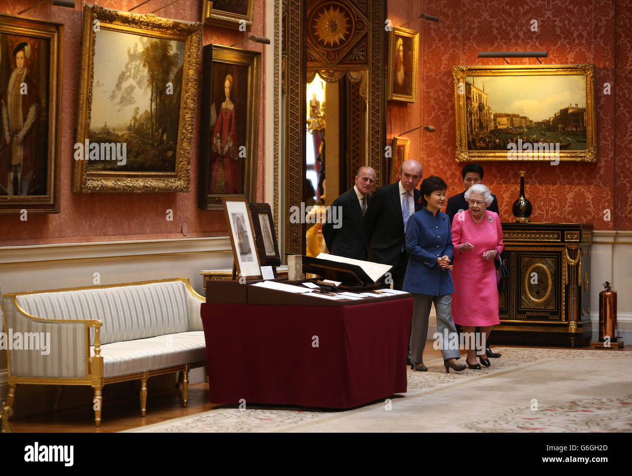 The President of the Republic of Korea Park Geun-Hye (centre), the Duke of Edinburgh (left) and Queen Elizabeth II (right) arrive to look at an exhibition of Korean related items from the Royal Collection and Royal Archives in the Picture Gallery of Buckingham Palace in London, England. The President of the Republic of Korea Park Geun-Hye is on a State Visit to the United Kingdom and during the trip she will attend a state banquet and visit Downing Street. Stock Photo