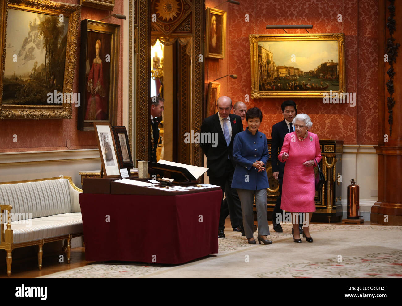 The President of the Republic of Korea Park Geun-Hye (centre), the Duke of Edinburgh (second left) and Queen Elizabeth II (right) arrive to look at an exhibition of Korean related items from the Royal Collection and Royal Archives in the Picture Gallery of Buckingham Palace in London, England. The President of the Republic of Korea Park Geun-Hye is on a State Visit to the United Kingdom and during the trip she will attend a state banquet and visit Downing Street. Stock Photo